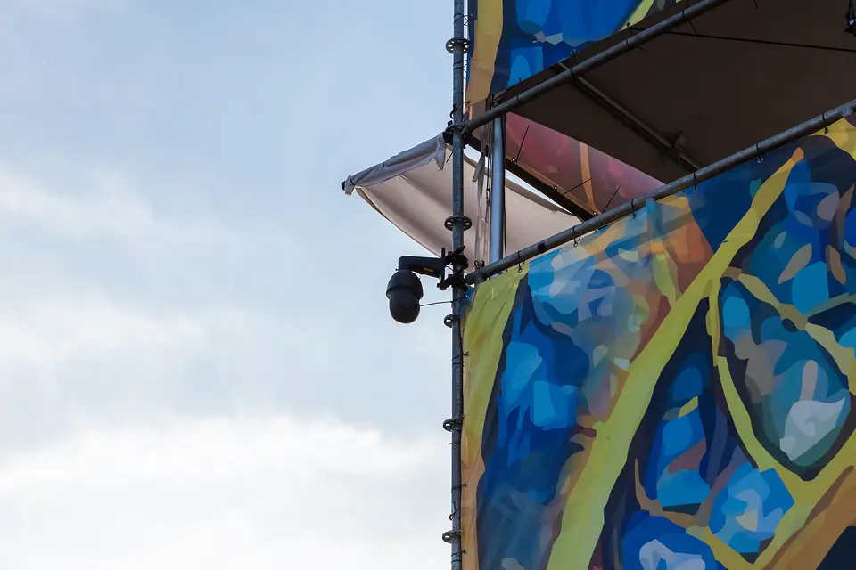 Camera discreet weggewerkt in de beschilderde decorwand van Rijvers Festival